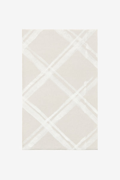 Fabric swatch featuring a diagonal plaid pattern in white paint on sand.