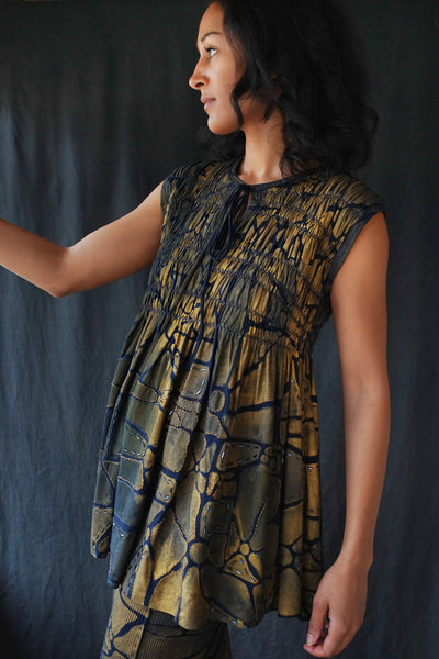 Model wearing the Kemi Tunic in Gold and Navy.