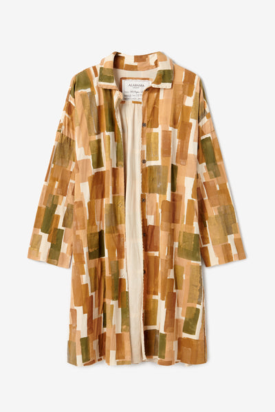 The Cirrus Coat, a long single-breasted coat with painted geometric design in earth tones.