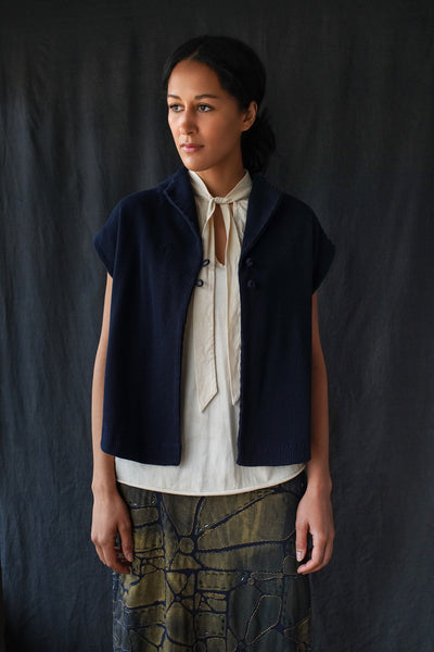 Model wearing the sleeveless Rosch Jacket in Navy.