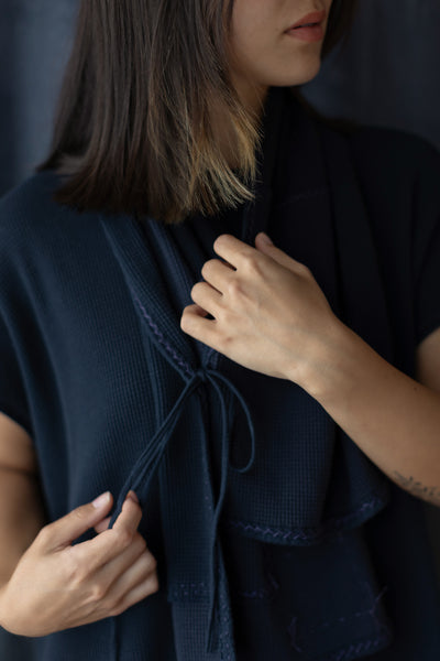 The Zero Waste Tied Waffle Scarf in Navy on Model.
