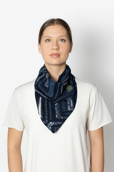 The Sonia Beaded Bandana, shown tied around a model's neck.