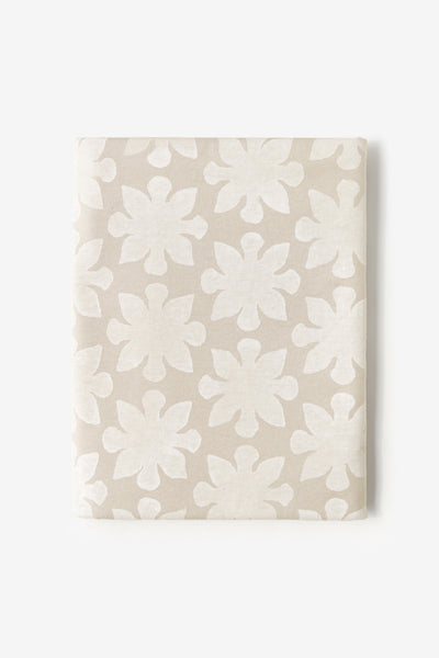 Wax fabric painted with the Tessellation design in white paint. Fabric is shown folded.